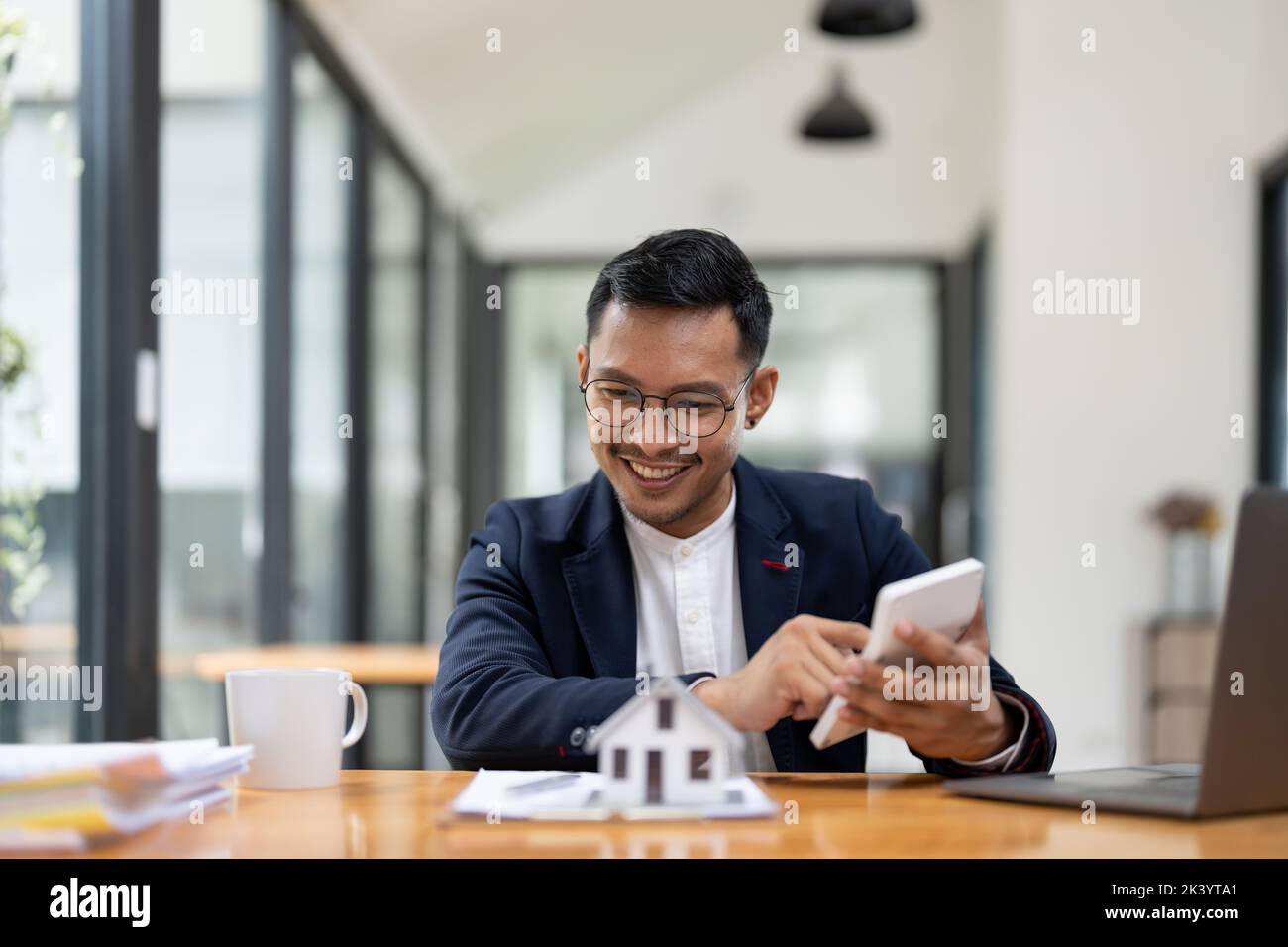 Business man agent calculating loan of finance and investment for real estate, businessman and invest in property about home, construction or mortgage Stock Photo