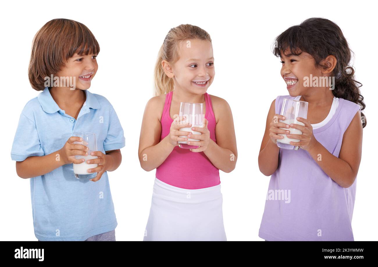 Getting their calcium for the day. Three young friends holding glasses of milk against a white background. Stock Photo