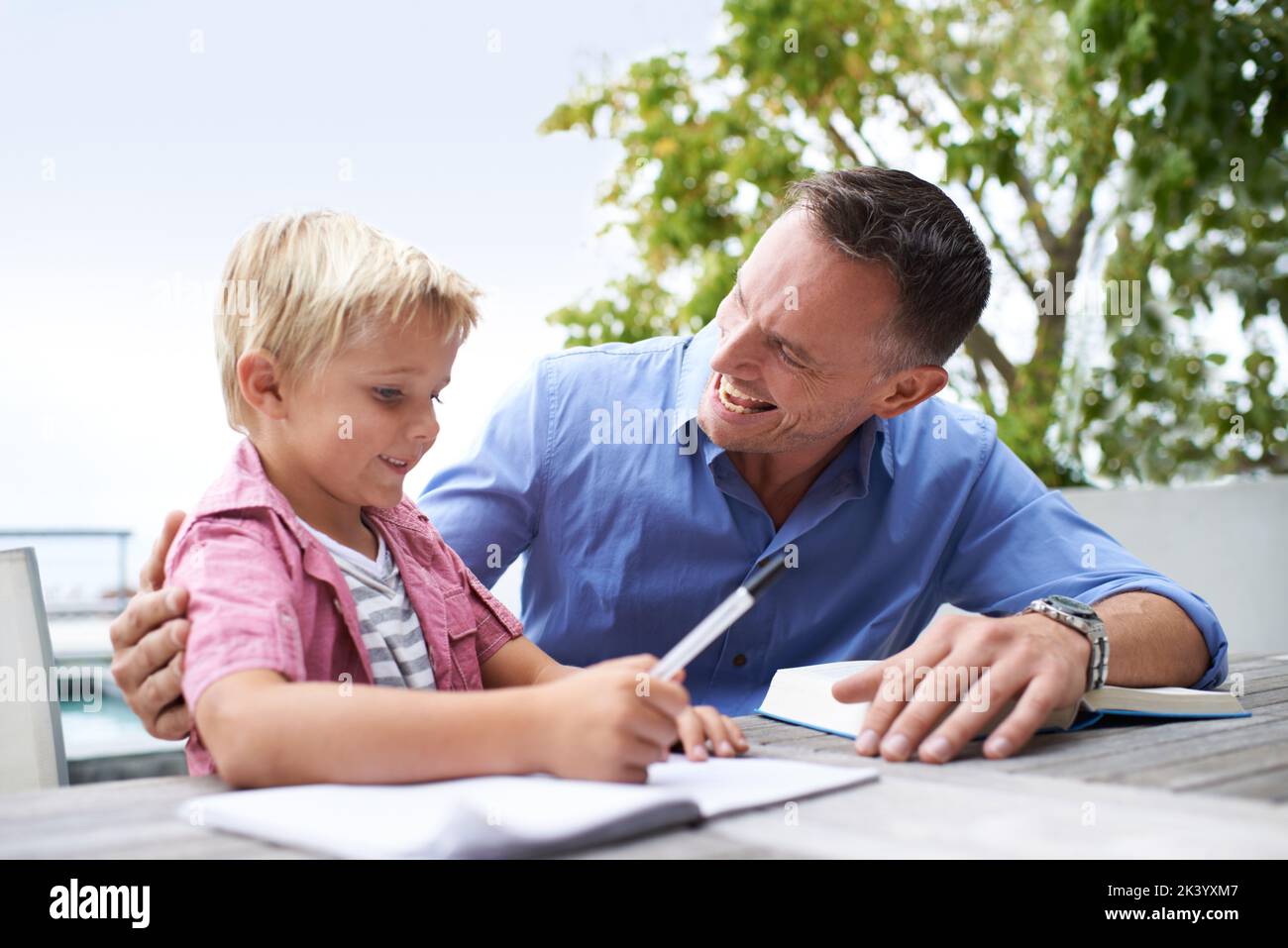 Male bonding. a father helping his son with his coloring book. Stock Photo