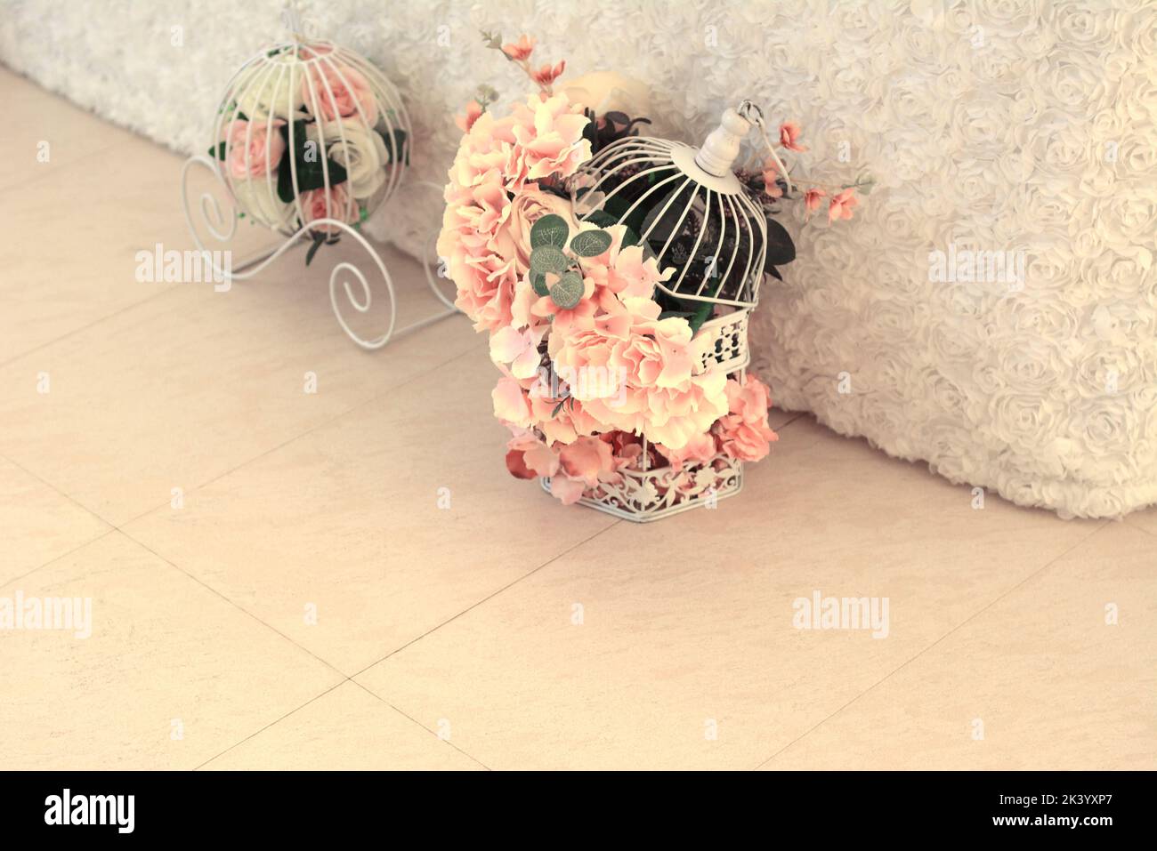 Artificial flowers in a bird cage Stock Photo Alamy
