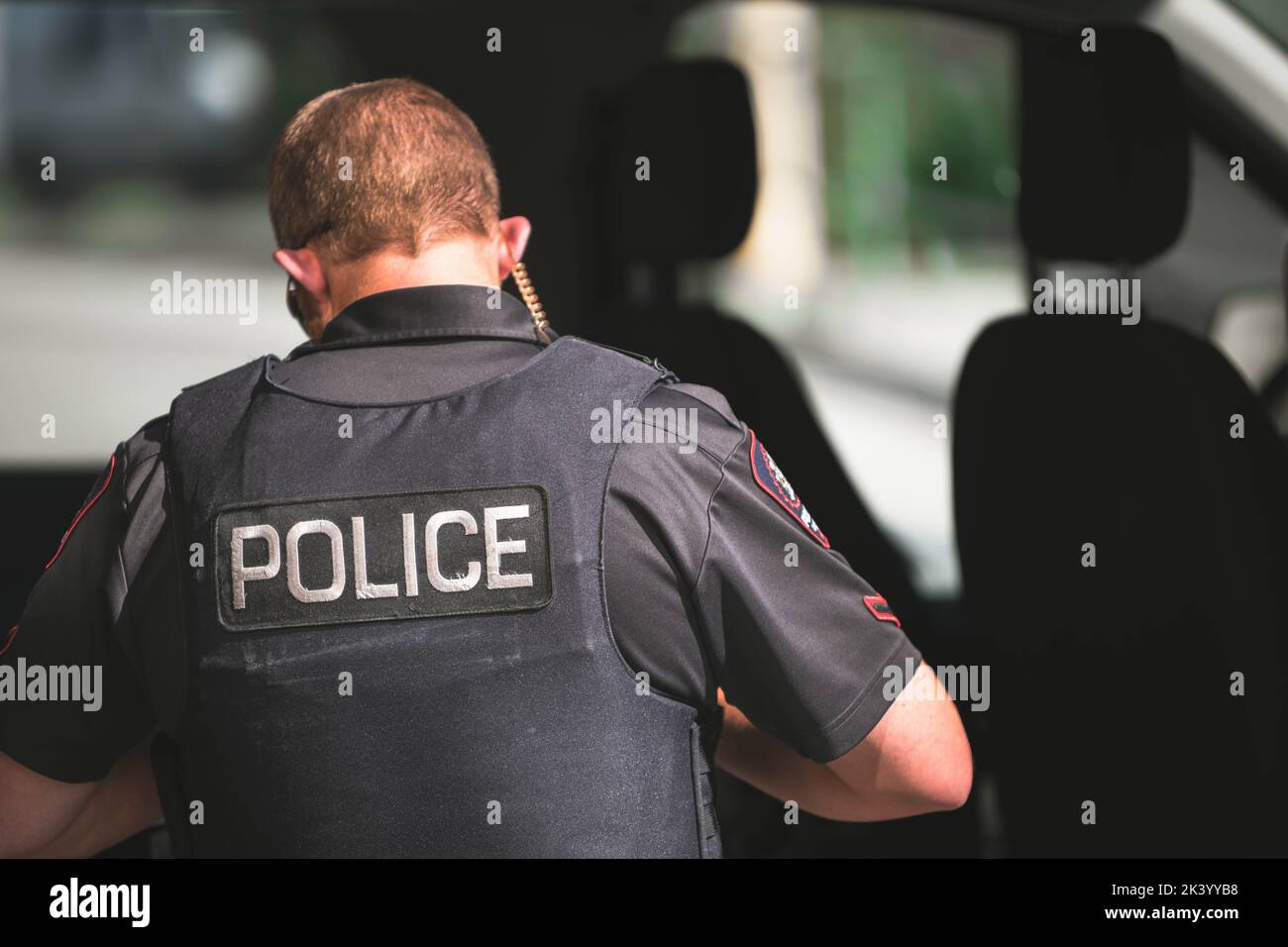 A back view of police officer wearing uniform Stock Photo Alamy