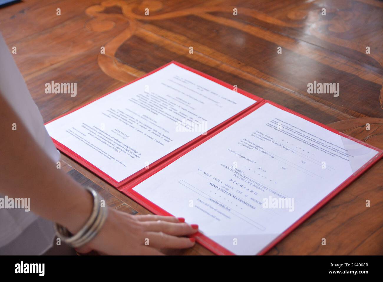 Italian marriage certificate on wooden table Stock Photo - Alamy