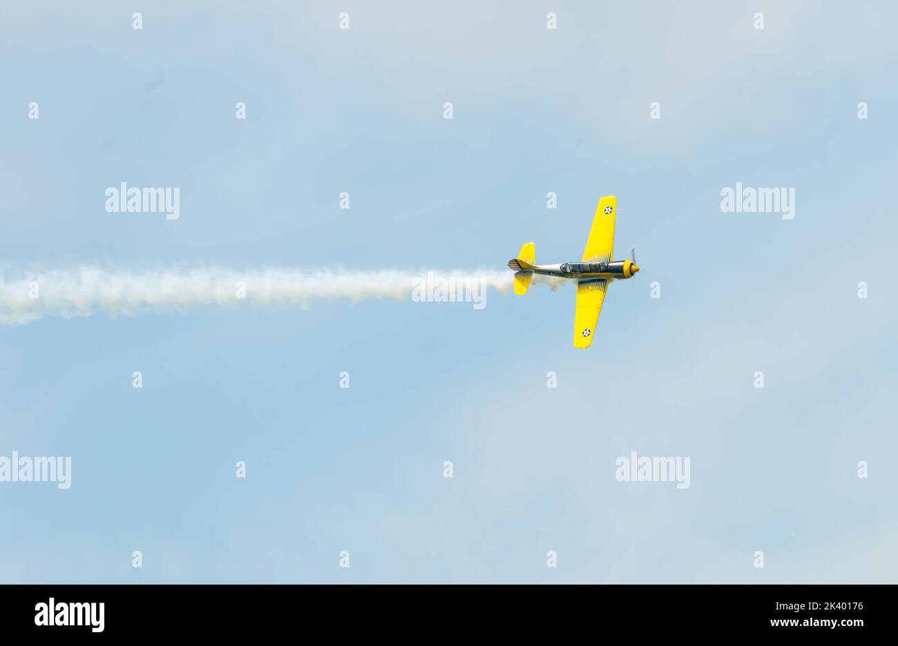Airshow performed by propeller plane on a clear sky Stock Photo - Alamy
