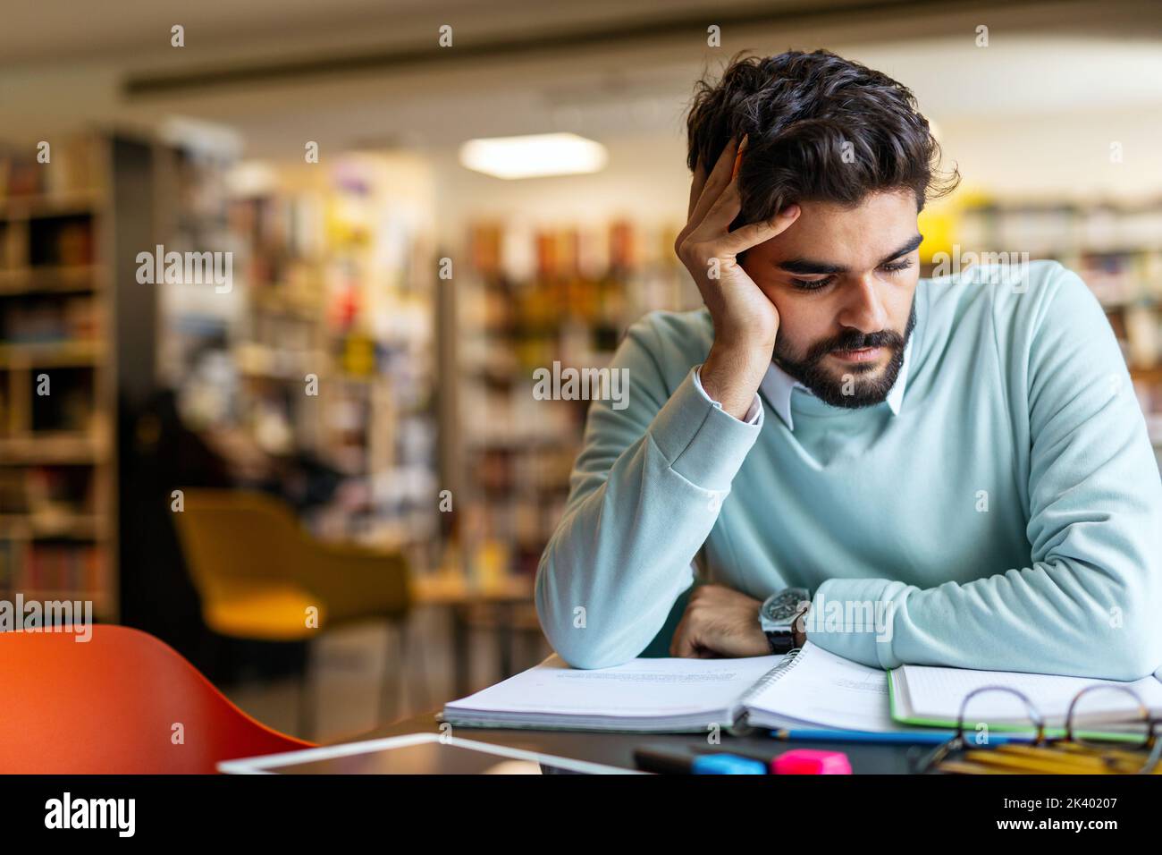 Portrait of young male student studying in a library. Education study teenager concept Stock Photo