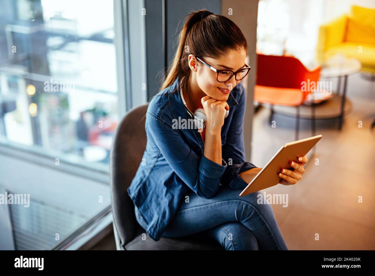 Portrait of happy young woman with a digital tablet. Business student people technology concept. Stock Photo