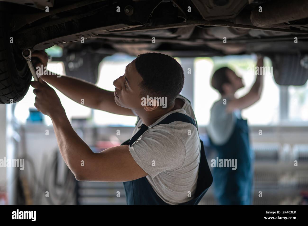 Professional car technicians repairing the client car Stock Photo