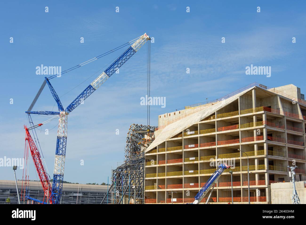 Various cranes, cargo, tower and jib cranes at the construction site Stock Photo