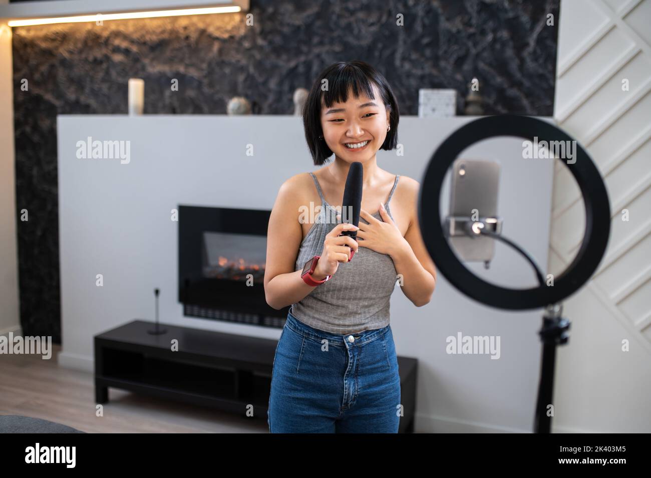 Asian vlogger live-streaming her vlog from home to her audience Stock Photo