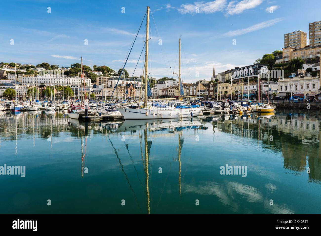 Boats moored in the harbour reflected in the calm water of the Inner Dock. Torquay, Devon, England, UK, Britain Stock Photo