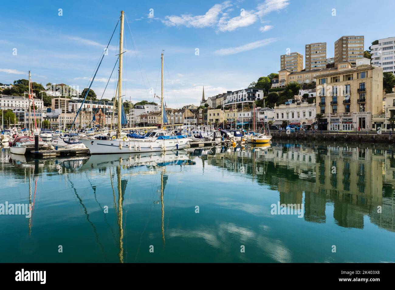 Boats moored in the harbour  reflected in the calm water of the Inner Dock. Torquay, Devon, England, UK, Britain Stock Photo
