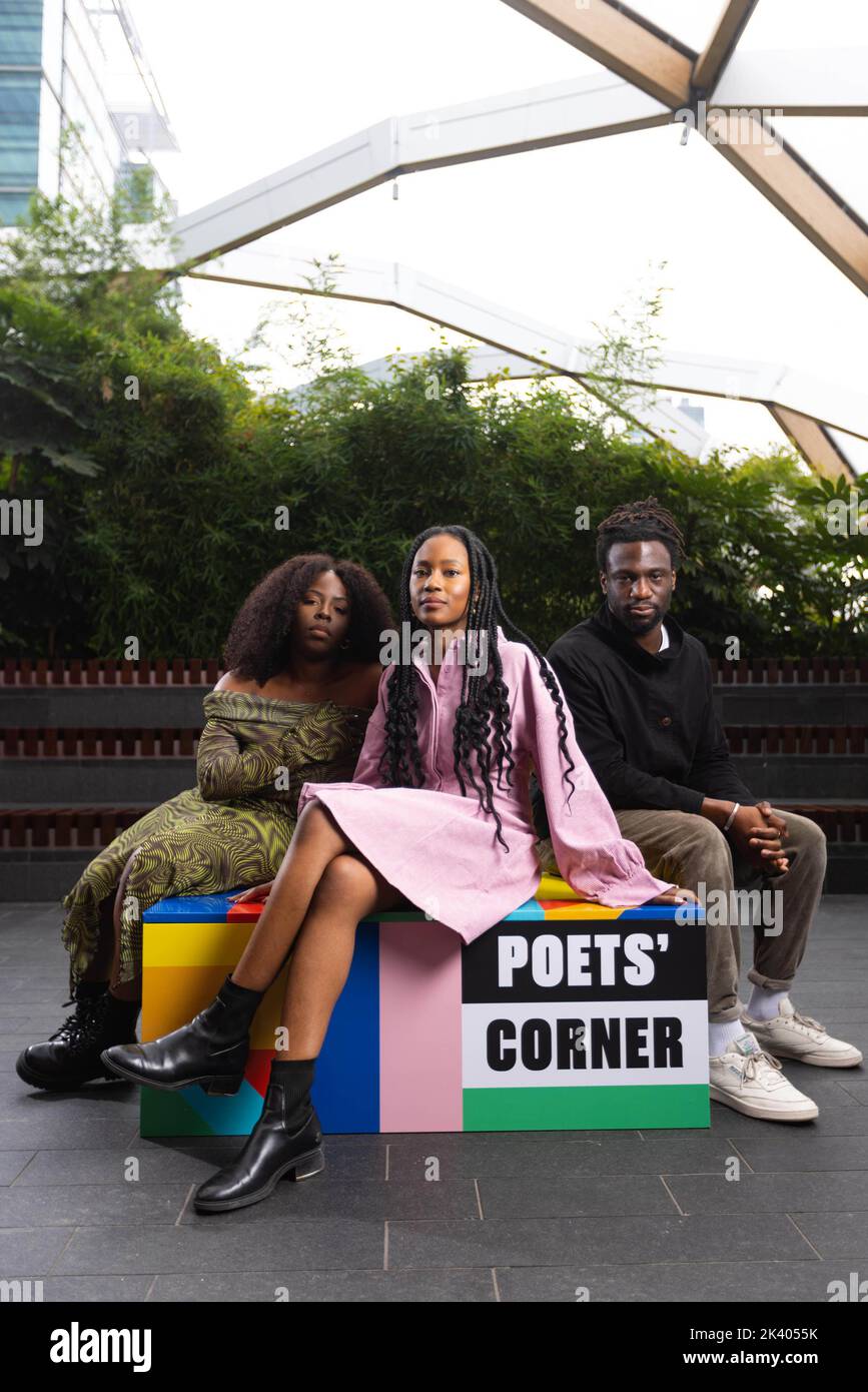 EDITORIAL USE ONLY Young People's Laureate Theresa Lola (middle) and poets Sarah Aluko (left) and Jolade Olusanya unveil 'Poets' Corner at Canary Wharf to celebrate Black History Month and provide a platform for young Black poets across London. Issue date: Thursday September 29, 2022. Stock Photo