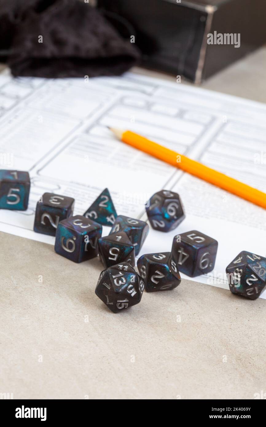 Dungeons and Dragons, a game of dice and imagination. Dice on grey with copy space Stock Photo