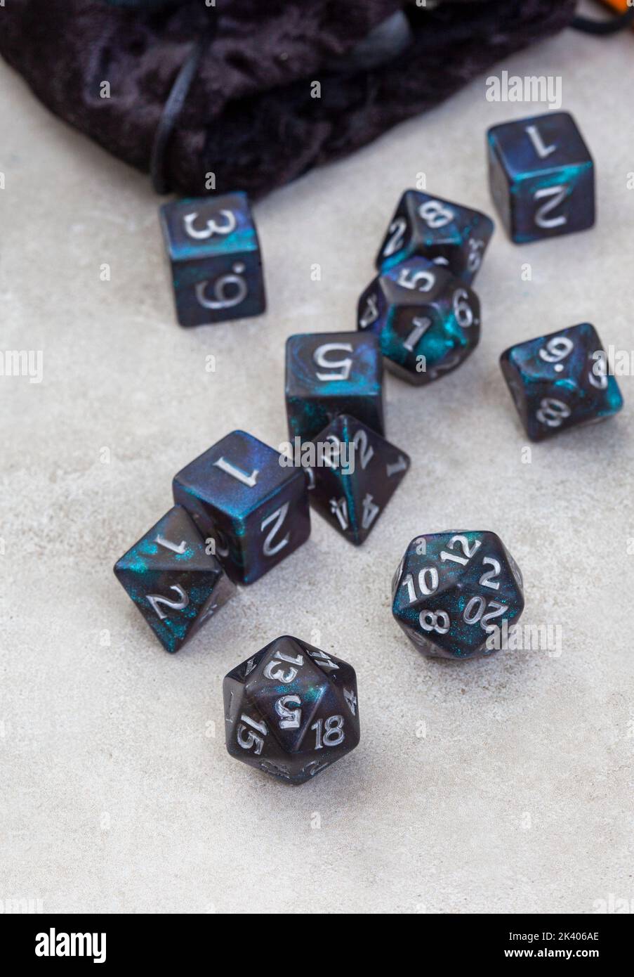 Dungeons and Dragons, a game of dice and imagination. Dice on grey with copy space Stock Photo