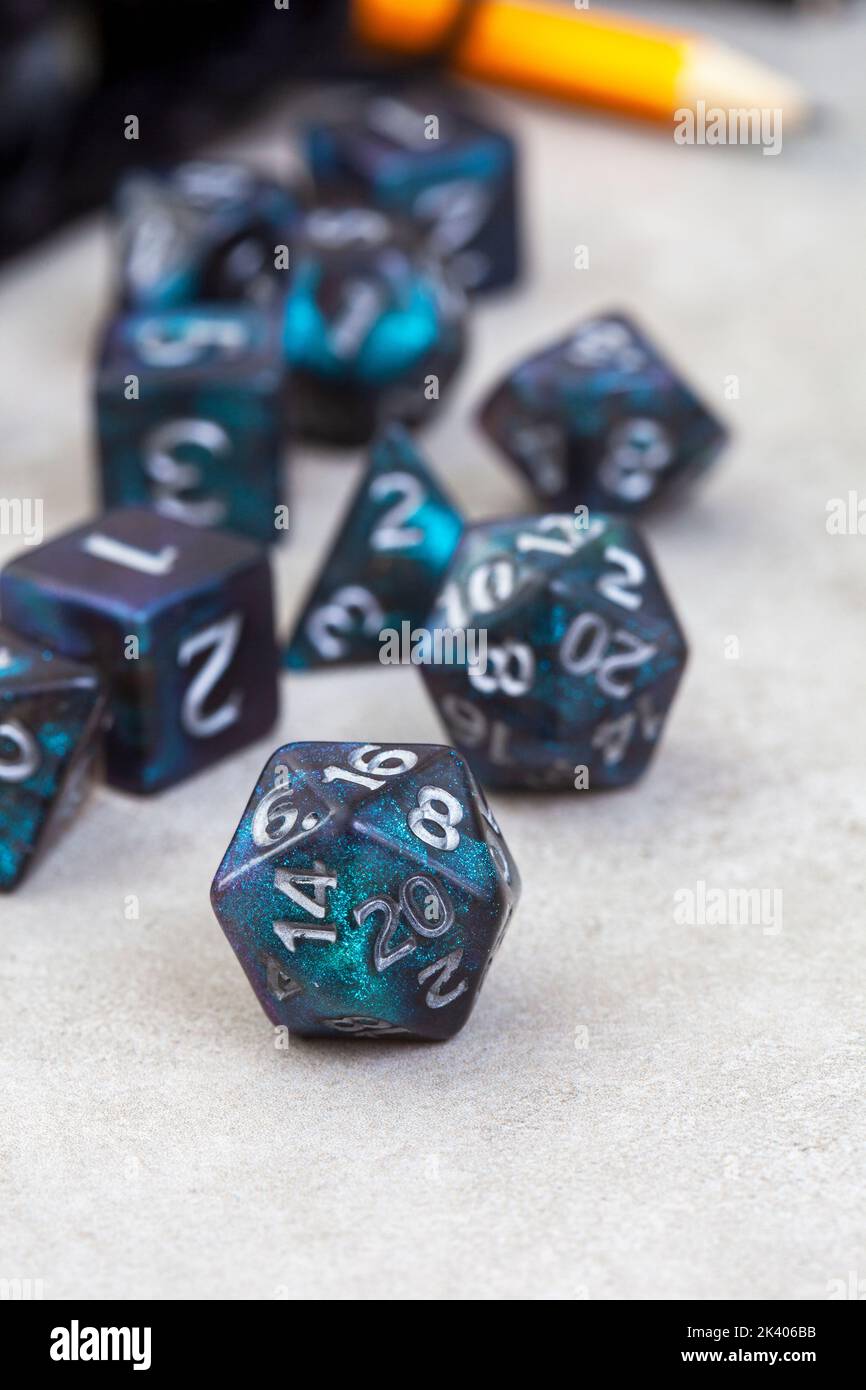 Dungeons and Dragons, a game of dice and imagination. Dice on grey with copy space Stock Photo