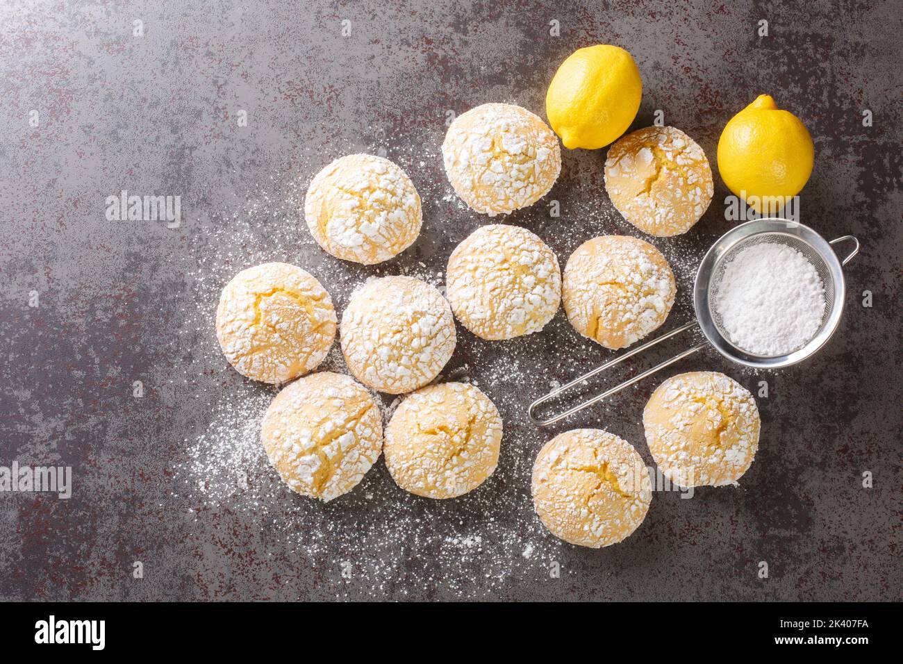 Close-up of cracked lemon biscuits sprinkled with powdered sugar close-up on the table. horizontal top view from above Stock Photo
