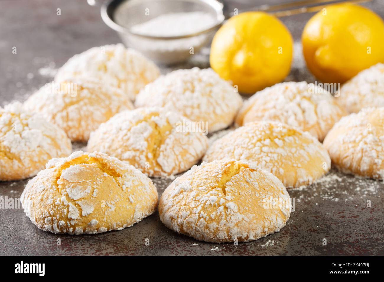 Festive homemade cracked lemon cookies with powdered sugar close-up on the table. horizontal Stock Photo