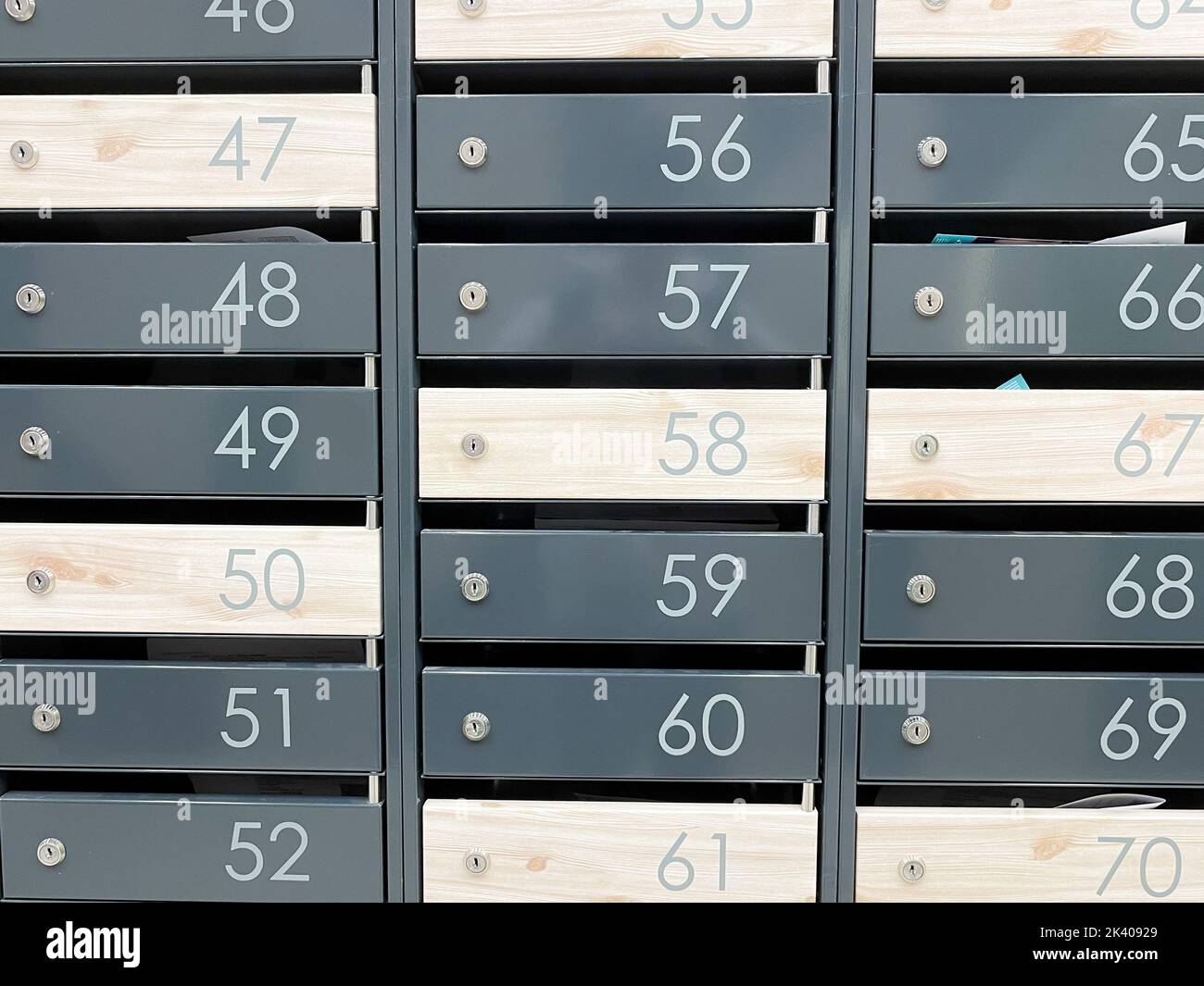 Even rows of numbered mailboxes. Metal mailboxes near the entrance in