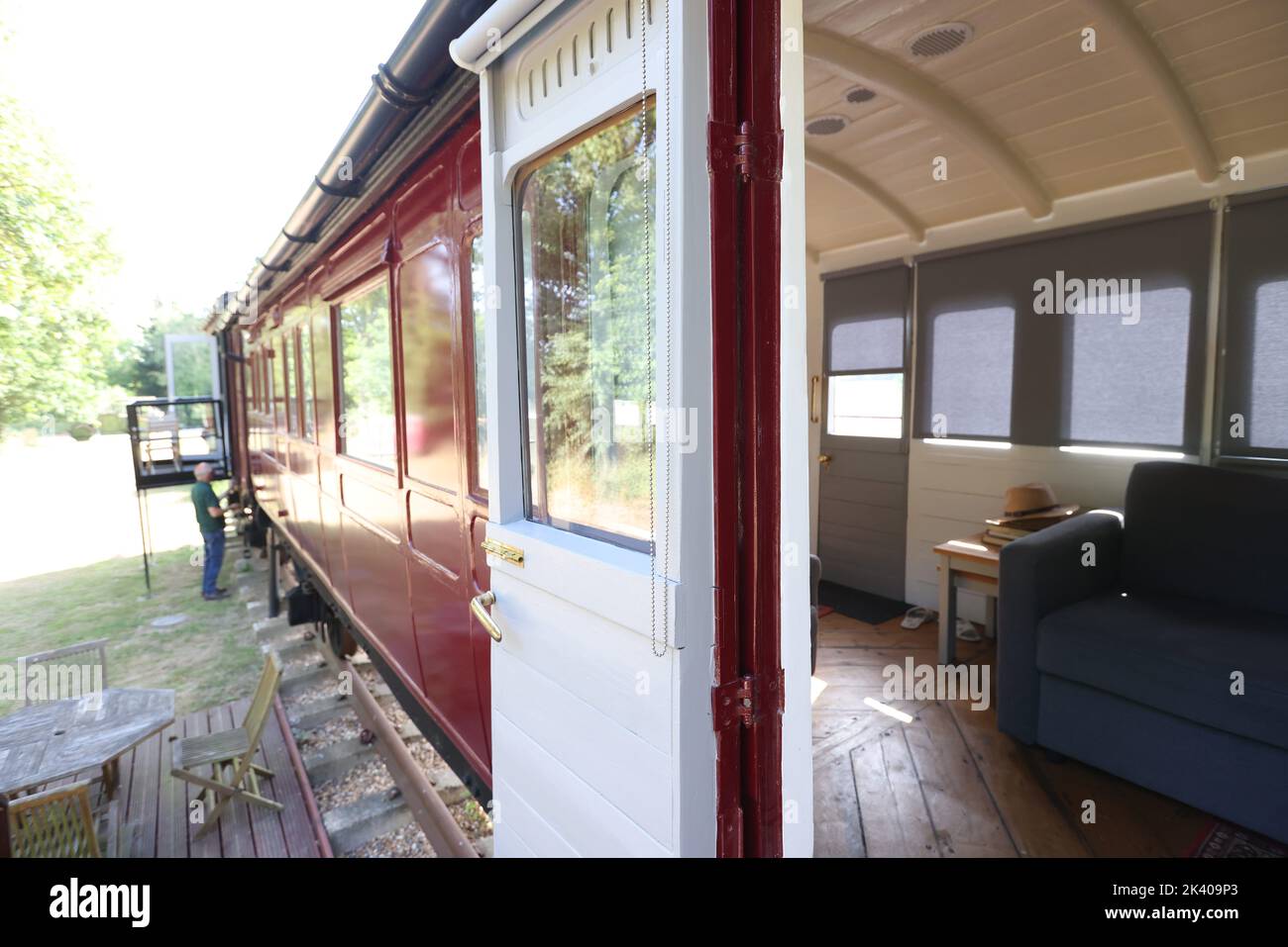 James Waters (with Dad Robin) alongside the 1880s train carriage which they one an award for as a quirky holiday letting property, Halstead, Essex UK Stock Photo