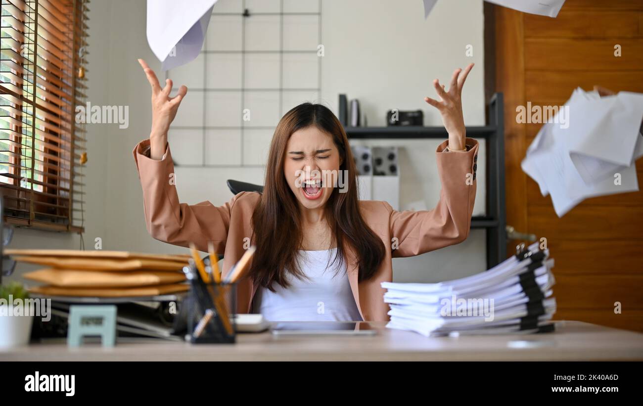 Angered, furious, crazy and mad millennial Asian businesswoman or