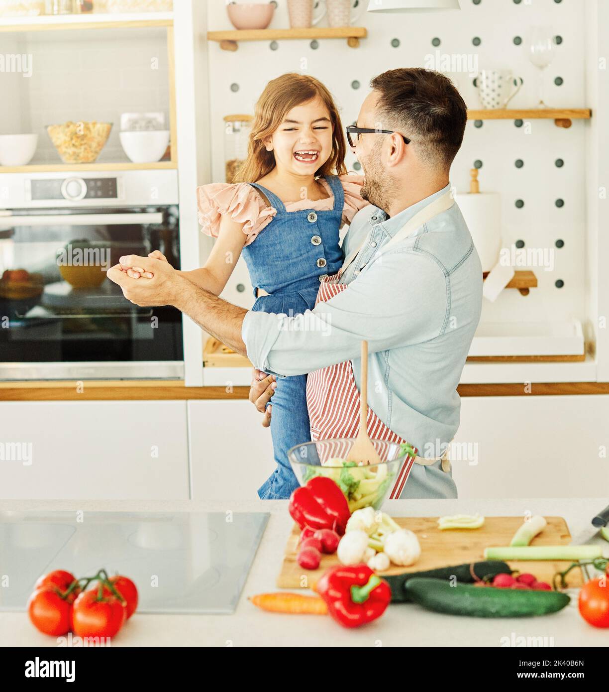 daughter father kitchen food preparing cooking child bonding happy girl together home parent dancing fun Stock Photo