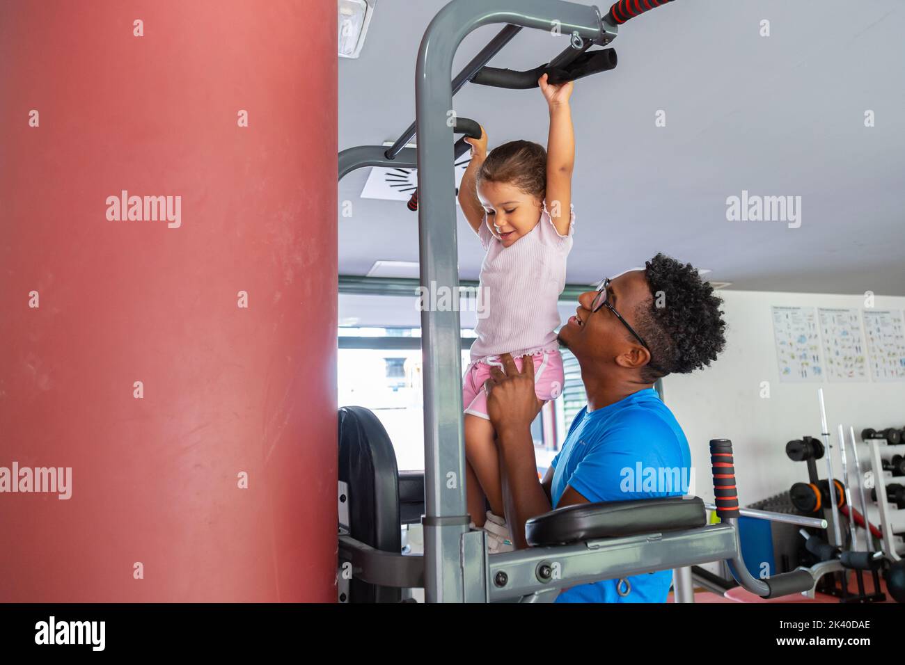 Dad teaching daughter to do pull ups Stock Photo Alamy