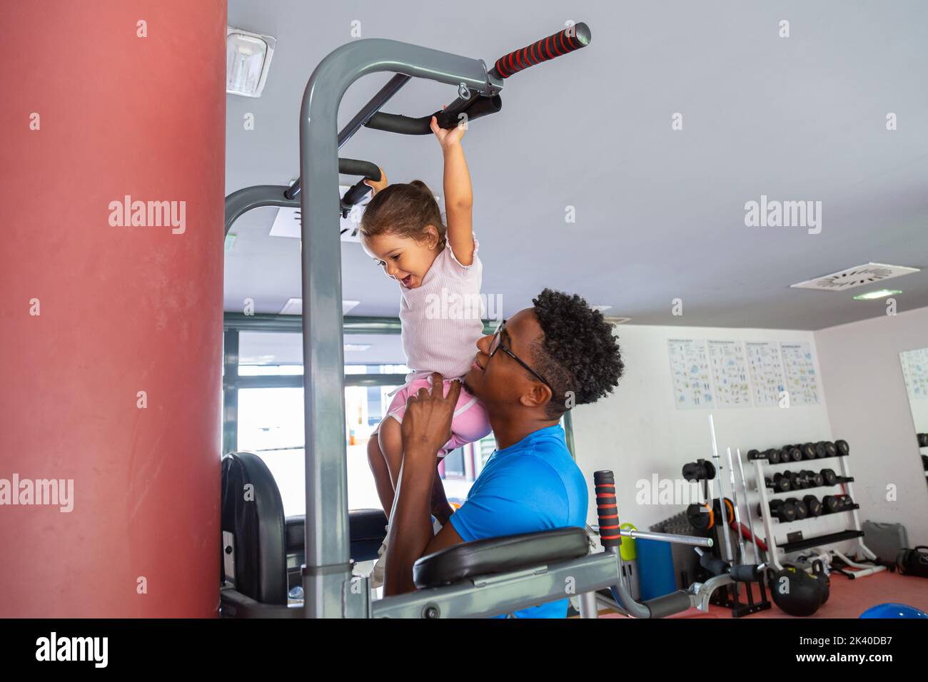 Dad teaching daughter to do pull ups Stock Photo Alamy