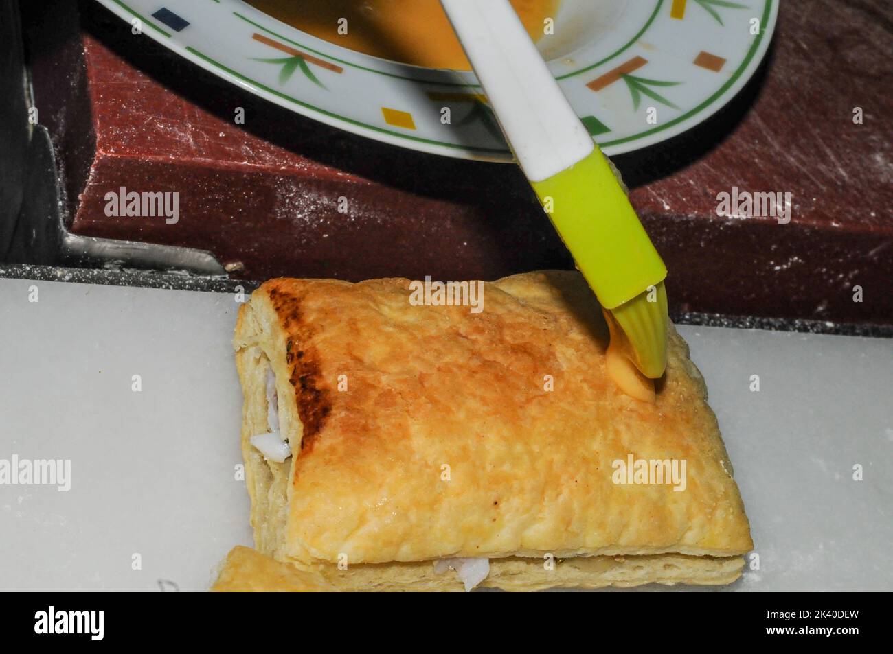 Artisan elaboration of puff pastries stuffed with hake. Stock Photo