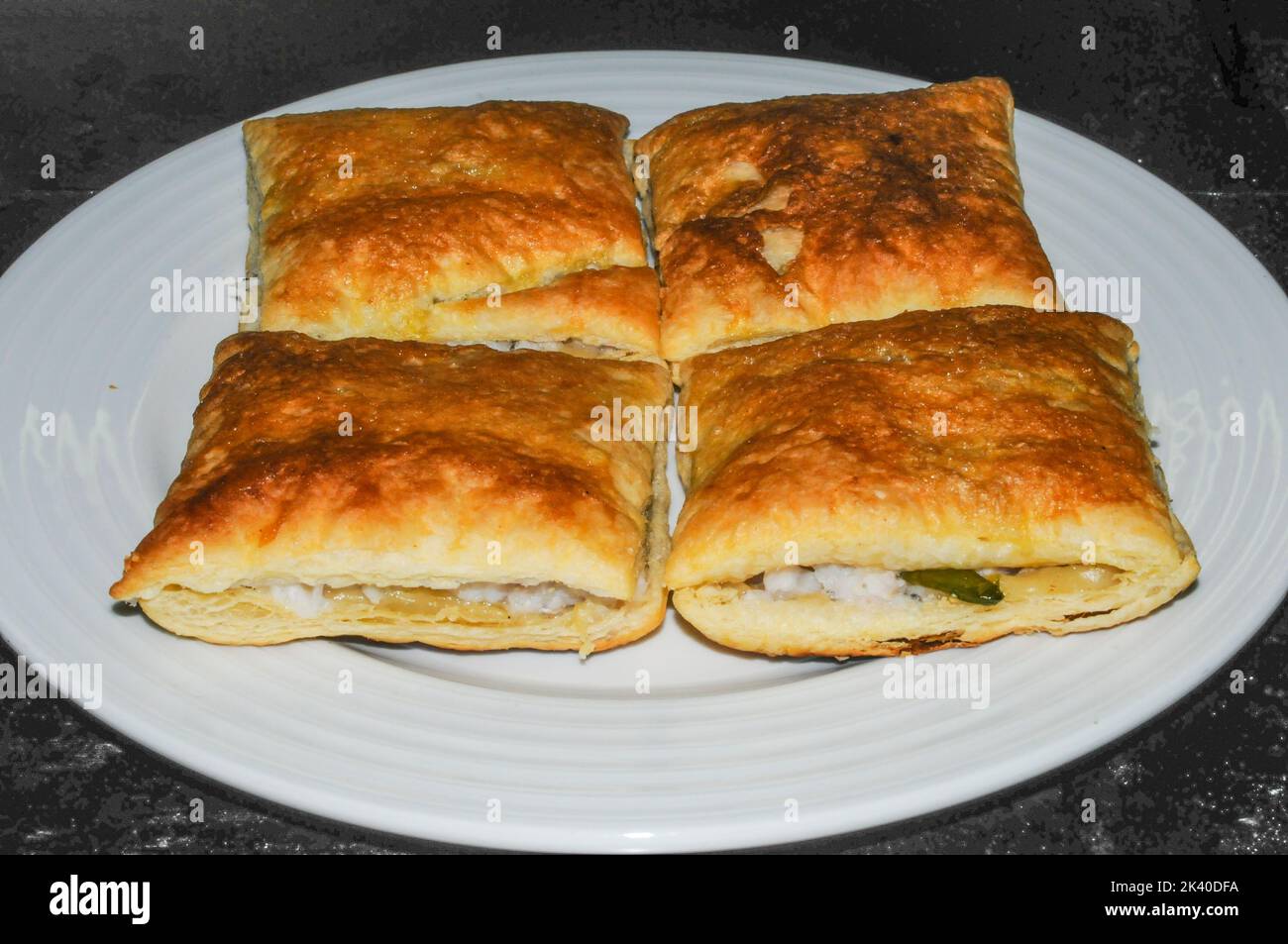 Homemade freshly baked puff pastries stuffed with hake Stock Photo