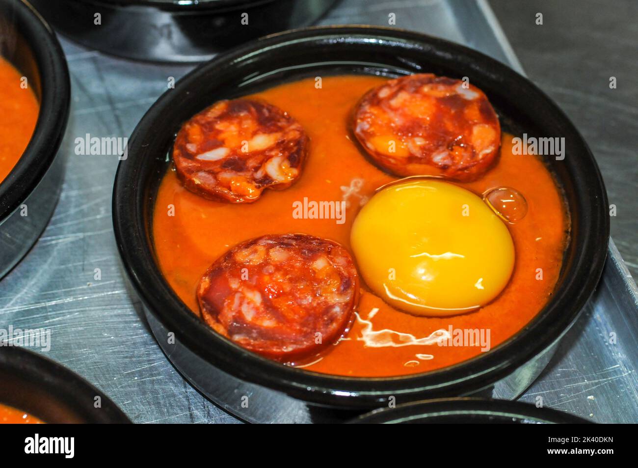 Eggs Flamenca - Eggs poached in tomato sauce. Stock Photo