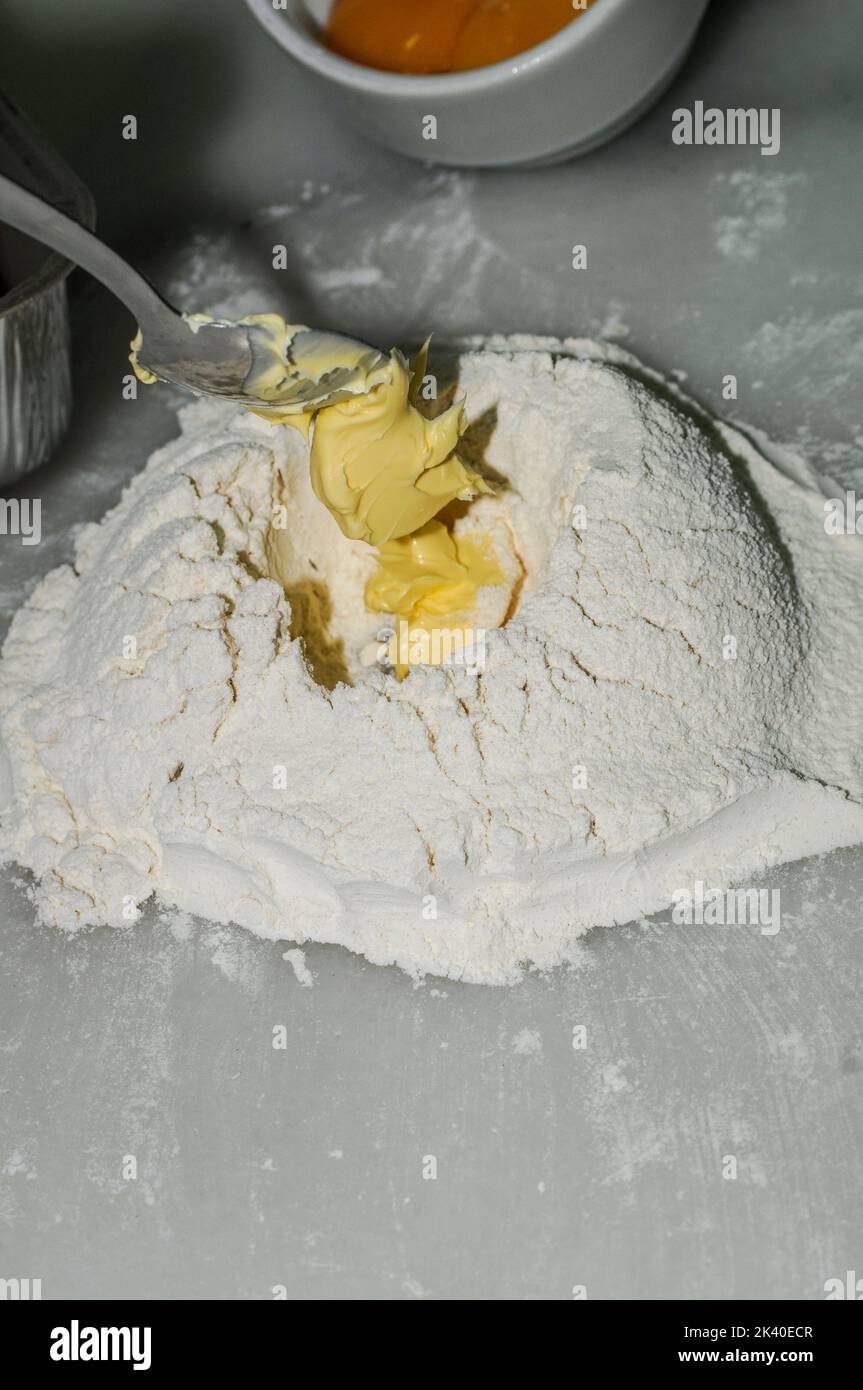 Volcano of flour to knead the shortcrust pastry Stock Photo