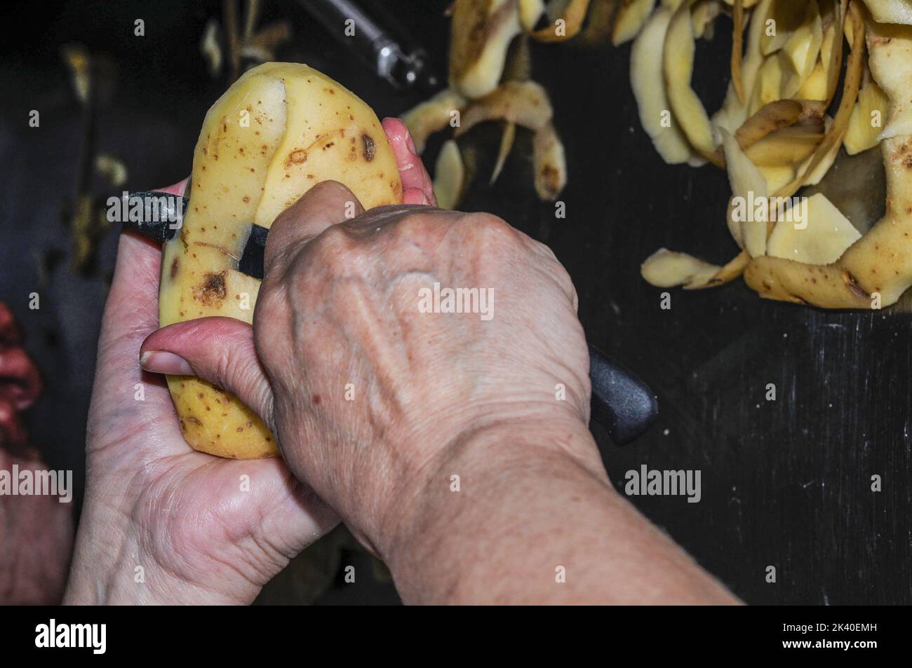Woman peeling raw potato hi-res stock photography and images - Alamy