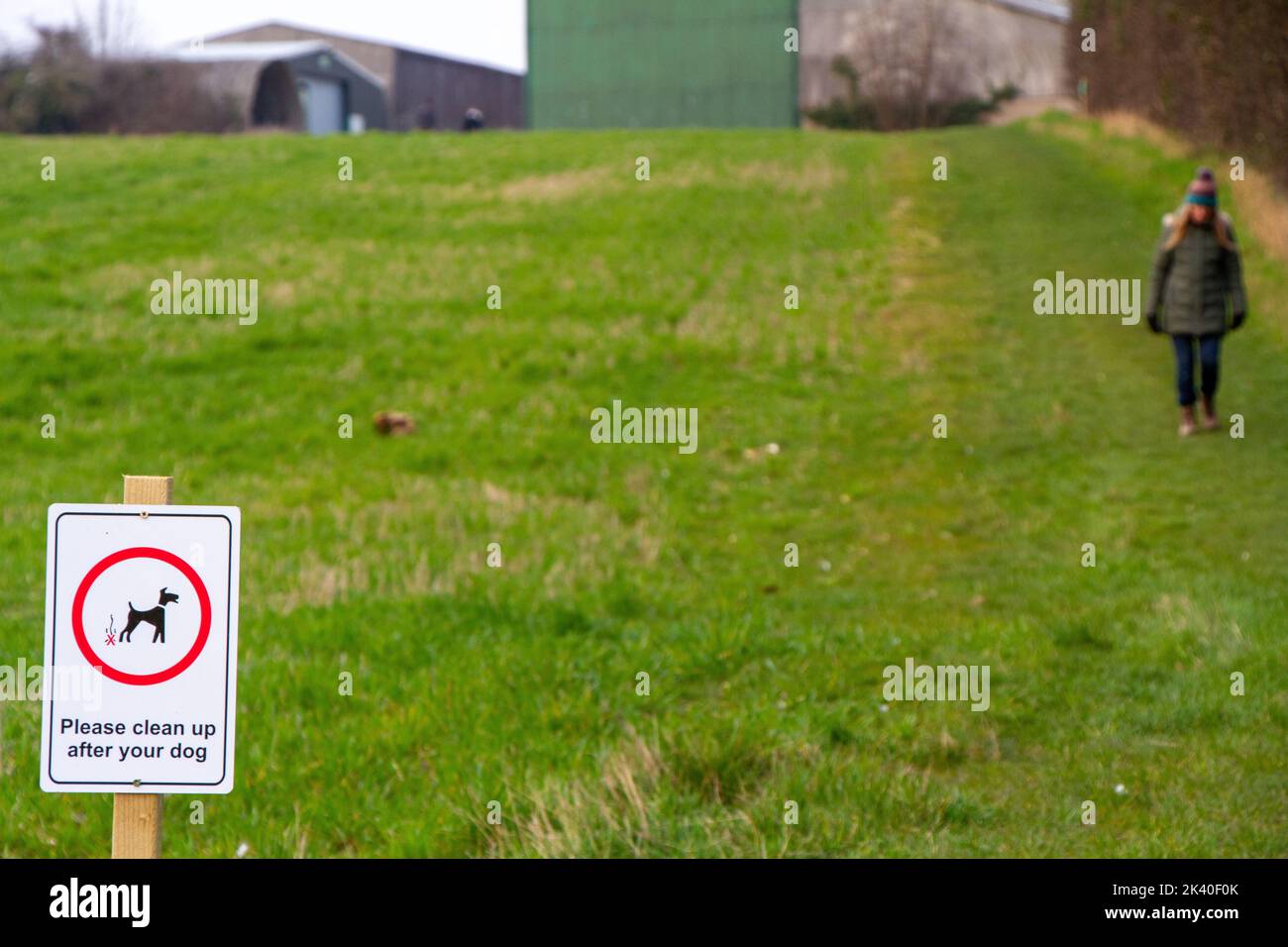 Sign by a public footpath on farming land for dog walkers to clean up after their pet Stock Photo