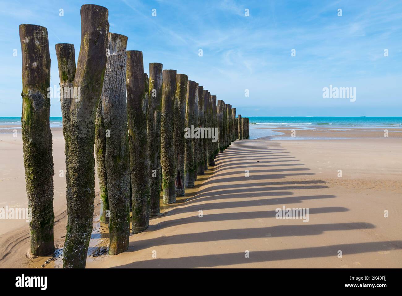 beach in france with wooden poles and the channel between france and england Stock Photo