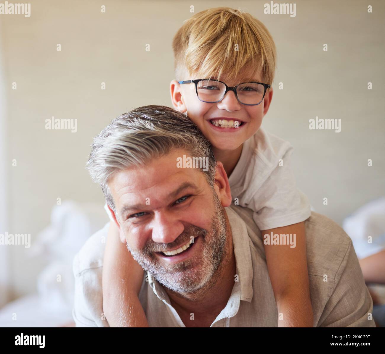 Family, children and love with a man and his child at home, laughing and having fun with a smile together. Kids, happy and smile with a cute boy and Stock Photo