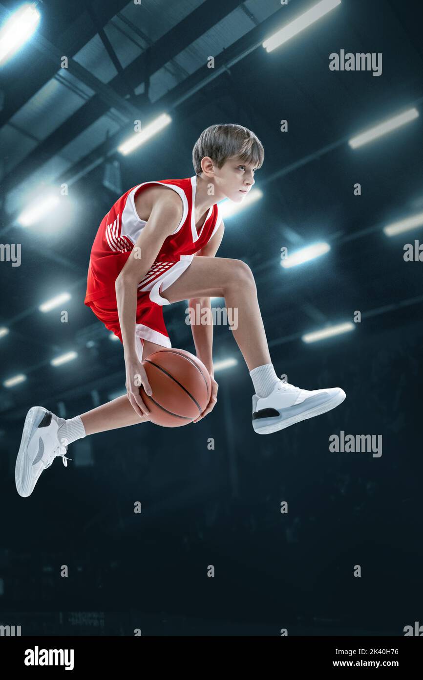 Portrait of teen boy, professional basketball player scoring goal in a