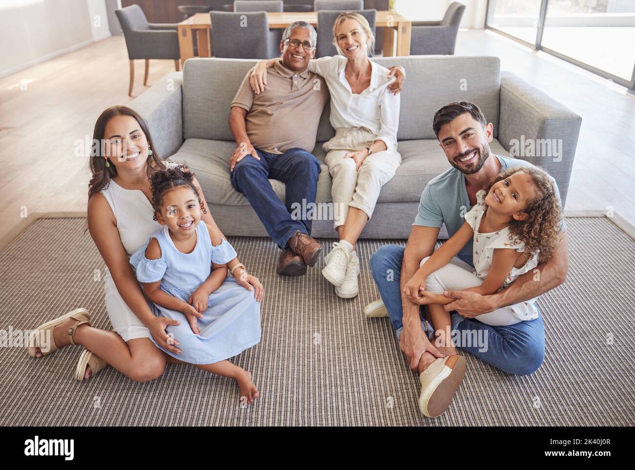 Interracial family portrait, children with grandparents with love, hug and smile together. Happy elderly mother, father and kids together with adult Stock Photo