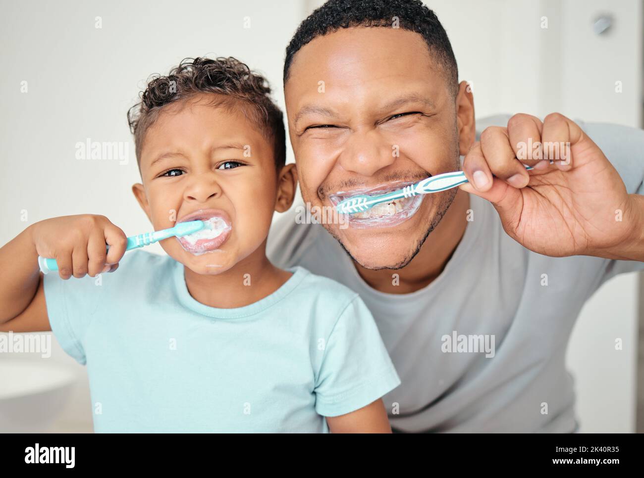 Portrait of dental dad, kid brushing teeth and healthy mouth cleaning in home bathroom. Happy father teaching child oral healthcare, wellness and Stock Photo