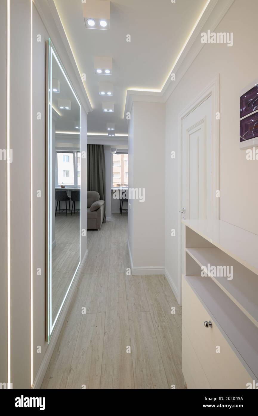 White long narrow hallway with a mirror Stock Photo Alamy