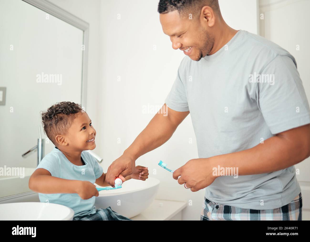 Dental, father and child brushing teeth with a toothbrush in a bathroom for healthy, wellness and oral care together. Happy young kid, boy and son Stock Photo