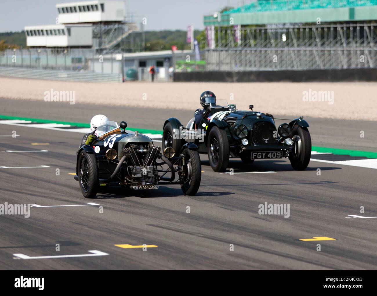 Sue Darbyshire in the Morgan Super Aero, passing Alan Middleton's  Aston Martin Speed 'Red Dragon', during the MRL Pre-War Sports Cars 'BRDC 500' Race Stock Photo