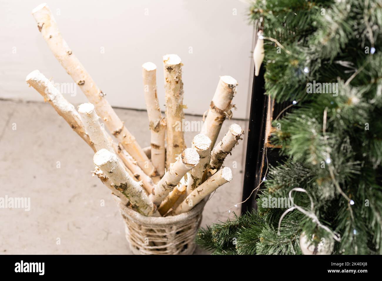 New Year decor of the Christmas tree. Wooden box with birch logs, decorated. Stock Photo