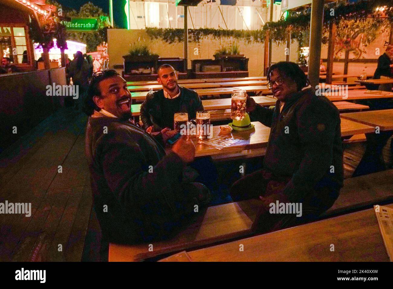20-09-2022 Munich, Germany. Oktoberfest in Munich - documentary - people (Latin Americans(?) with big mugs of beer. One person - emotionally happy! Stock Photo