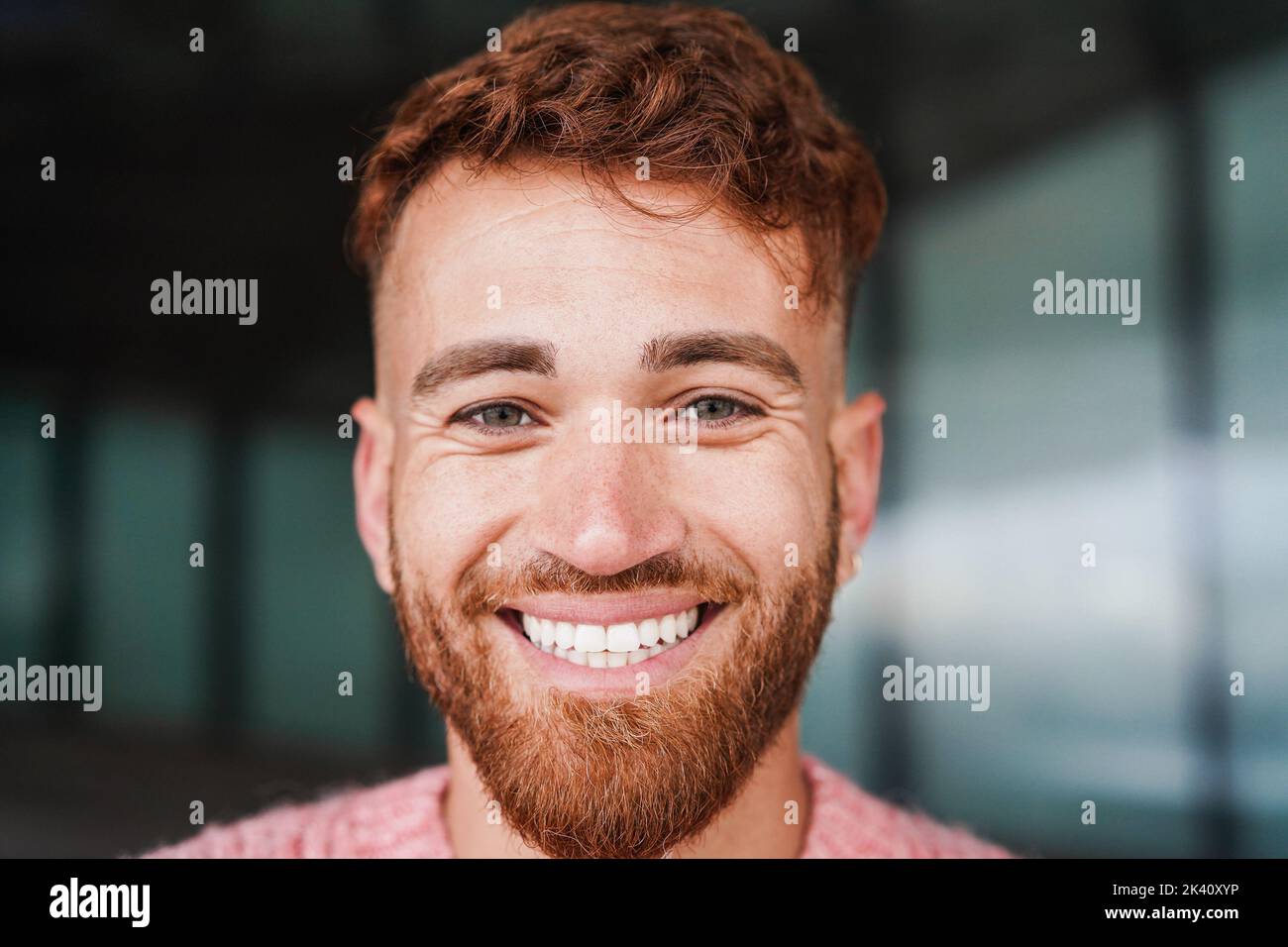 Young red hair man smiling on camera outdoor Stock Photo