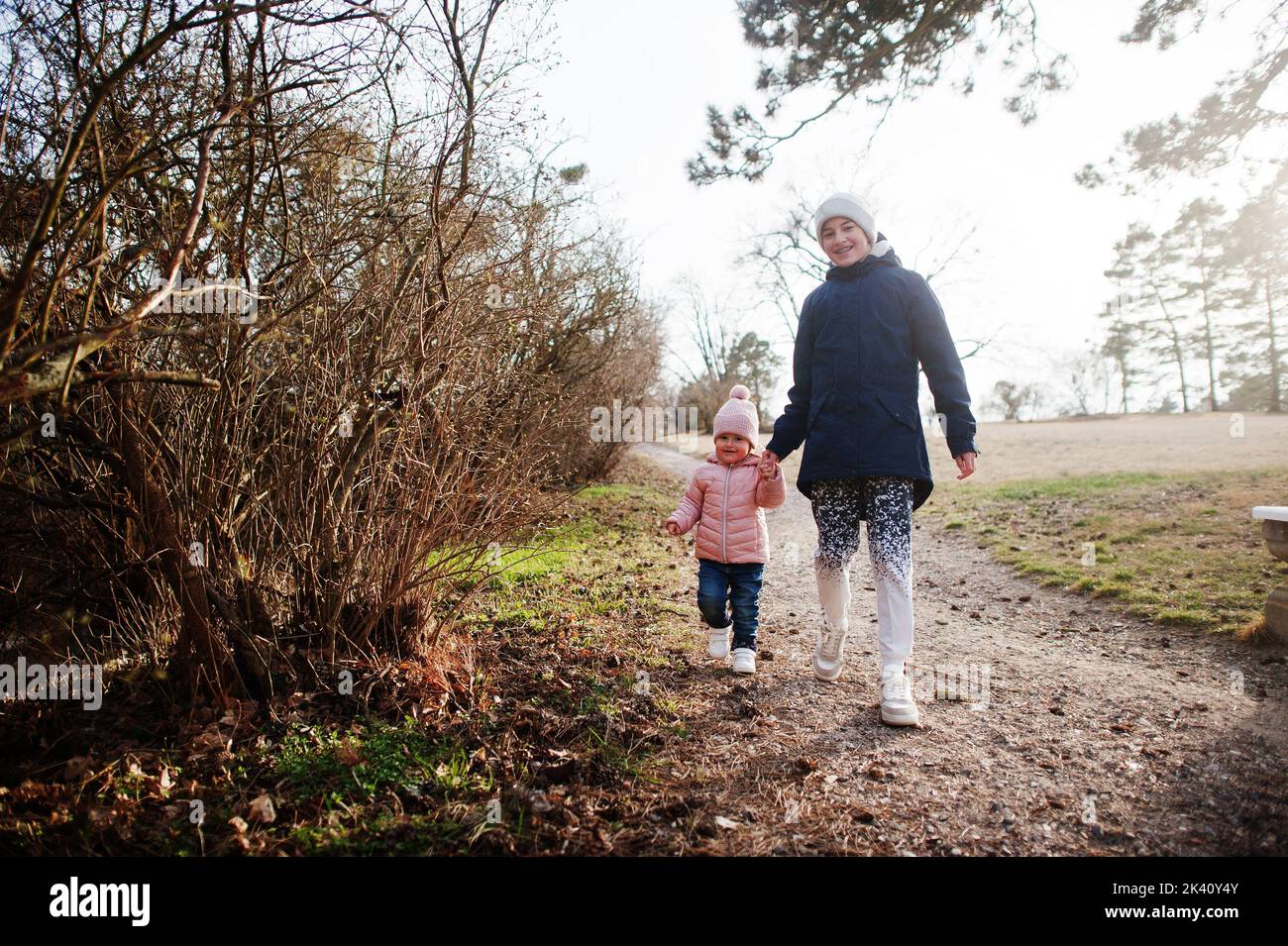 Brother sister holding hand walking hi-res stock photography and images ...