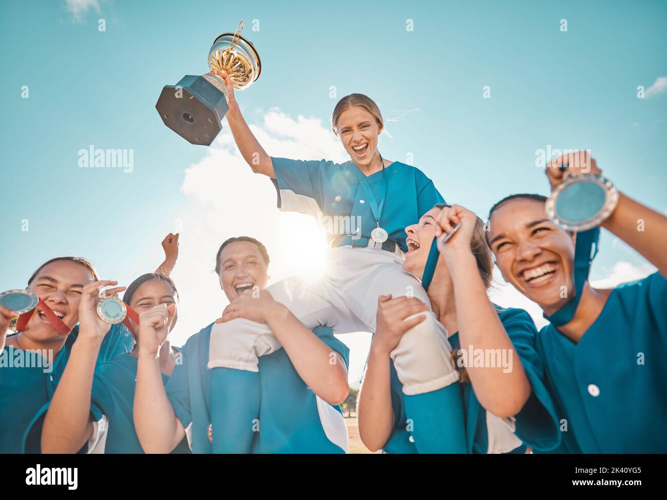 Women trophy, sports game and win for school baseball kids, happy winner in celebration and support for teamwork after sport goal. Portrait of Stock Photo