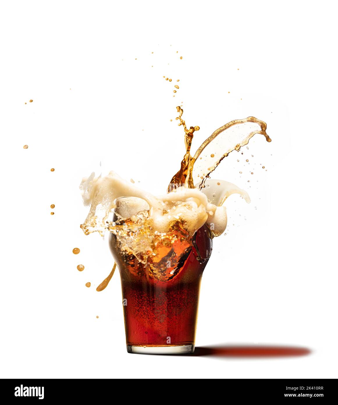 Ice cube falling into beer glass creating huge foam splashes. Glass