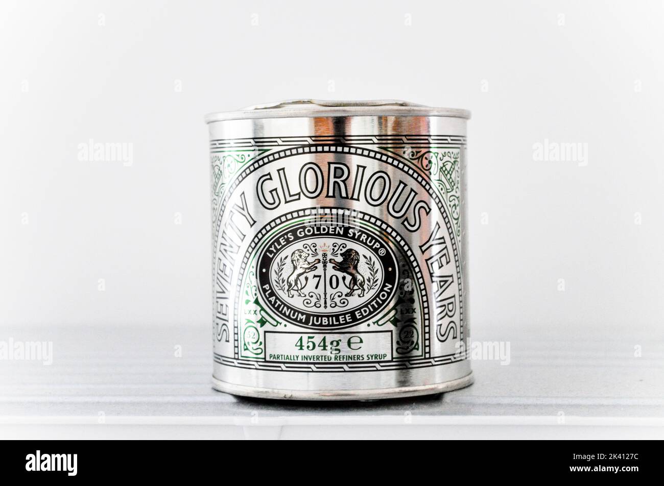 Special edition Lyle's Golden Syrup tin set against a white background. Seventy Glorious Years Platinum edition. Stock Photo