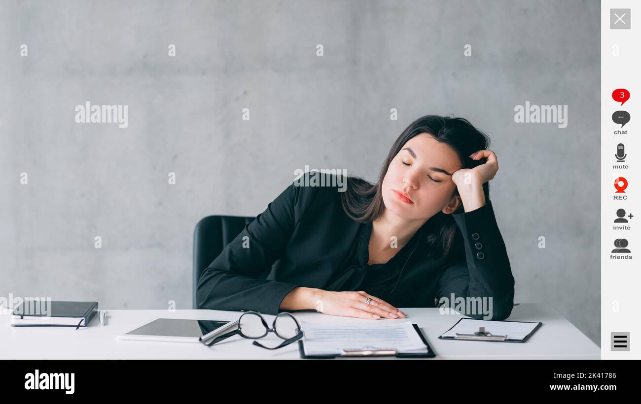 Virtual conference. Boring woman. Screen mockup. Sleeping lady sitting desk leaning hand having online webinar in light room interior. Stock Photo