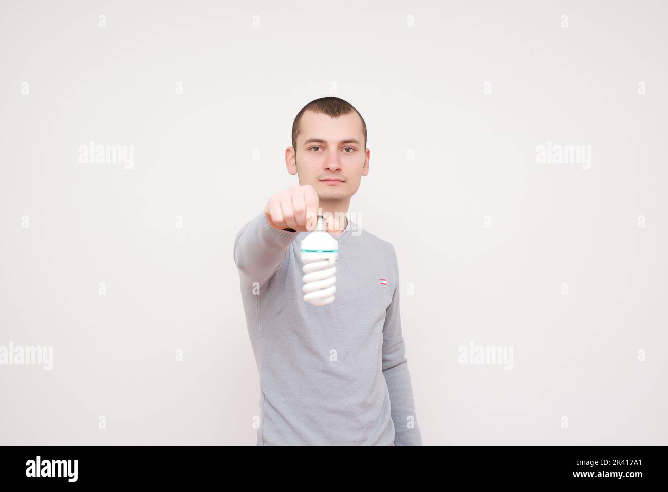 Man holding fluorescent light bulb in hand stock photo Stock Photo - Alamy