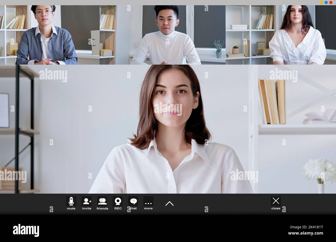 Virtual meeting. Webinar view. Screen mockup. Female coach having online conference with two men and woman in light room interior. Stock Photo